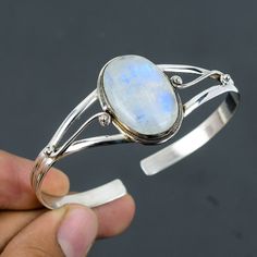 Note: Due to the natural formation of this gemstone. Slight variation in design and color are to be expected. Rainbow Moonstone Bangle 925 Sterling Silver Bangle Adjustable Cuff Bracelet Handmade Designer Bangle Natural Gemstone Jewelry Gift For Him SKU  : VC-56 Handmade Cuff Bracelet Gemstone : Rainbow Moonstone Stone Shape : Oval Metal Purity : 925 Sterling Silver Cuff Bracelet Size : Adjustable Rainbow moonstone is thought to bring balance, harmony and hope while enhancing creativity, compassion, endurance and inner confidence. Rainbow moonstone is believed to help strengthen intuition and psychic perception, especially offering us visions of things that aren't immediately obvious. Payalcreations is committed to delivering the best quality sterling silver jewelry to customers. As a hand Sterling Silver Oval Gemstone Cuff Bracelet, Oval Sterling Silver Gemstone Cuff Bracelet, Sterling Silver Cuff Bracelet With Natural Stones, Moonstone Gemstone Cuff Bracelet Bangle, Elegant Moonstone Cuff Bangle Bracelet, Elegant Moonstone Bangle Cuff Bracelet, Silver Oval Bangle With Gemstone, Cuff Bracelets Handmade, The Bangles