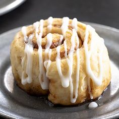 some kind of pastry with icing on top of it sitting on a metal plate