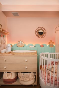 a baby's room with a crib and dresser