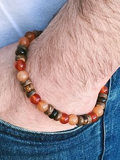 Men's Bracelet, Sacral Chakra Bracelet, Orange Aventurine, Orange Carnelian, Tiger's Eye This beautiful bracelet is made of 8mm Orange Aventurine beads, 8mm Orange Carnelian beads, 8mm Tiger's Eye rondelle beads, and coconut shell spacers. The bracelet shown fits to 7.5 inches wrist but you can choose your own wrist size. Orange Aventurine *Heart and Sacral Chakra *It is a stone for good luck and fortune and a manifestor of new possibilities *It is called the ''Whisper Stone'' because its energy Adjustable Brown Carnelian Bracelets, Eye Spiritual, Gemstone Accessories, Orange Aventurine, Spiritual Bracelets, Bracelet Chakra, Orange Carnelian, Bracelets Design, Tourmaline Bracelet