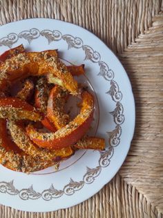 a white plate topped with sliced bell peppers on top of a woven tablecloth covered place mat