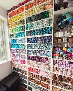 there are many crochet items on the shelves in this room that is filled with yarn