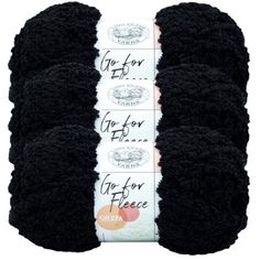 three black crochet yarns are stacked on top of each other in rows