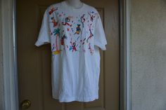 "Vintage 1990 hand embroidered. Size not labeled estimated size large to XLm - please see measurements. Single stitch! Great condition! Measurements taken across front laid flat 23\" across front armpit to armpit 30\" length" Vintage Embroidered Cotton T-shirt, Vintage Embroidered Crew Neck T-shirt, Hand Embroidered, Graphic Tshirt, T Shirts, Mens Graphic Tshirt, Mens Tshirts, Mens Tops, T Shirt