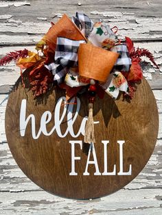 a wooden sign that says hello fall with an orange and black bow hanging from it