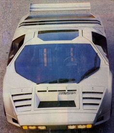 a white sports car parked on top of a parking lot