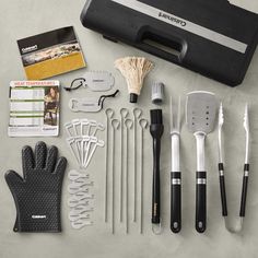 an assortment of kitchen utensils and tools laid out on a table