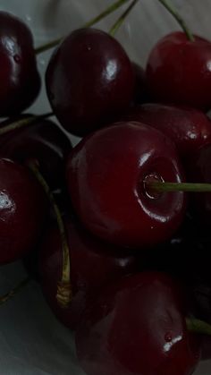 a bunch of cherries sitting on top of each other