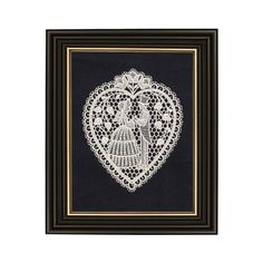 a black and white frame with an embroidered design on it