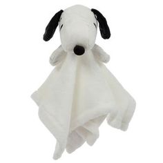 a white stuffed dog with black nose and ears on it's face is wrapped in a towel