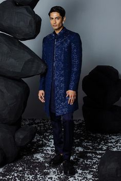 Navy blue silk open sherwani with crystal embellished geometric patterns. Comes with embroidered kurta and pant.
Components: 3
Pattern: Embroidered
Type Of Work: Sequin
Neckline: Sherwani and Kurta: Mandarin Collar
Sleeve Type: Sherwani: Full
Fabric: Pure silk
Color: Blue
Other Details: 
Weight: 1.5 kgs
Occasion: Cocktail and Reception - Aza Fashions Open Sherwani, Blue Sherwani, Indian Blue, Indian Men, Indian Men Fashion, Reception Dress, Silk Pants, Sherwani, Blue Silk