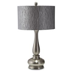 a table lamp with a gray shade on it and a silver base, sitting against a white background