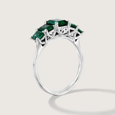 Spectacular. Stunning. Unforgettable. In our new Alexandrina ring we created a goldsmith masterpiece unlike anything else. Five large and deep-green emeralds are elevated above the ring with an elegant bridge decorated with our signature sign, forming an architectural perfection on your finger. It's not just a bling, the skilled craftsmanship and unique design turn the Alexandrina ring into a true heirloom that will never go out of style and will be passed through generations. **Due to the nature of the natural Emerald the color may vary** All features can be customized! please contact us if you wish to make changes, we love making custom designs. All of our jewelry is carefully handmade in our atelier *HC diamond are all conflict free diamonds To order by phone click here>> +972(0)7229910 Formal Green Sapphire Ring With Diamond, Formal Green Sapphire Diamond Ring, Emerald Ring With Vvs Clarity Round Cut, Formal Diamond Ring With Prong-set Emeralds, Luxury Emerald Cut Emerald Cluster Ring, Timeless Baguette Cut Green Emerald Ring, Emerald Rings With Accent Stones Princess Cut, Timeless Green Baguette-cut Emerald Ring, Emerald Ring With Princess Cut And Accent Stones