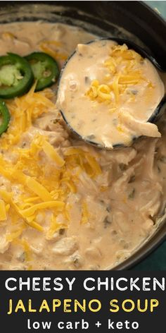 cheesey chicken jalapeno soup in a black crock pot with a spoon