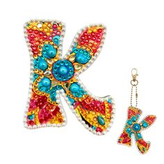 the letter k is made out of beads and has a keychain attached to it