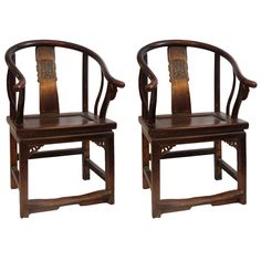 two wooden chairs sitting next to each other