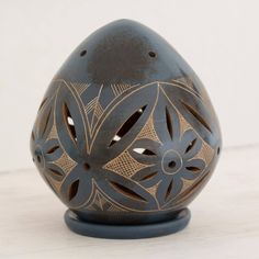 an egg shaped vase sitting on top of a table