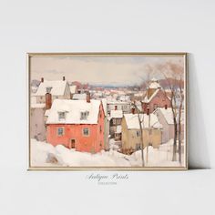 a painting of snow covered houses and trees in the foreground, framed on a white wall