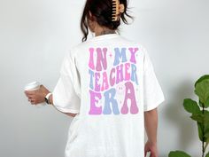 In my Teacher Era Shirt! In my Teacher Era Sweatshirt! 📍Handmade with Love! 📍Shirts are Unisex TShirts and SO Soft!! We proudly use Bella Canvas! 📍These are True to Size, Size Charts are provided on each listing. 📍Colors Available will be listed on each listing. 📍DESIGN is Sublimation.  📍Processing Time: 3-5 business days. Shipping Options available at check out. 📍Returns & Exchanges: No returns or exchanges will be accepted as these are made to order. If you have an issue with your item Teacher Sweatshirt, My Teacher, Love Shirt, Unisex Tshirt, School Shirts, Size Charts, Teacher Shirts, Teacher Appreciation, Bella Canvas