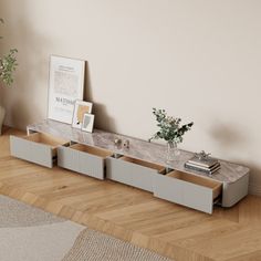 a living room with a plant and some pictures on the wall