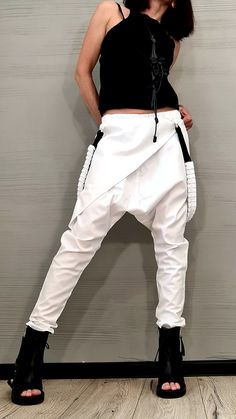 "Avant Garde Pants, White Harem Pants Women, Drop Crotch Pants, Extravagant Pants, Casual Pants, Urban Pants ❤️ Extravagant designs and high quality fabrics! ❤️ Materials & Care Textile, Polyamide, Cotton Hand wash at low temperatures. Do not machine dry. Do not iron. Do not dry clean! ❤️ Sizing We can make your piece from XS to 5XL! Everything in the shop can be also made according to your measures free of charge! ❤️ Shipping ✈ Ready to ship The time I need to prepare an order for shipping Avant Garde Pants, White Harem Pants, Steampunk Shoes, Paul Poiret, Gothic Pants, Drop Crotch Pants, Harem Pants Women, Fall Clothes, Pants White