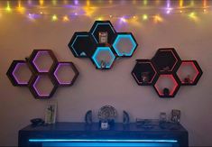 three hexagon shaped mirrors on the wall above a desk