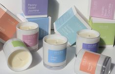 several different types of candles sitting next to each other