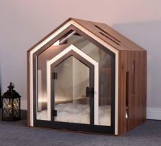 a wooden and glass house shaped like a bed