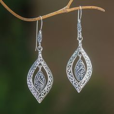 Crafted of sterling silver two baby leaves dangle within larger shapes in this pair of earrings from Bali. Wayan Asmana presents this wonderful accessory which is accentuated by a striking combination of finishes. Sterling Silver Leaf-shaped Jewelry With Ear Wire, Sterling Silver Leaf-shaped Earrings, Nickel-free Leaf-shaped Sterling Silver Earrings, Silver Leaf-shaped Jewelry With Ear Wire, Sterling Silver Leaf Earrings With Ear Wire, Hypoallergenic Sterling Silver Leaf-shaped Earrings, Elegant Sterling Silver Leaf-shaped Jewelry, Elegant Sterling Silver Leaf Jewelry, Nickel Free Sterling Silver Leaf-shaped Earrings