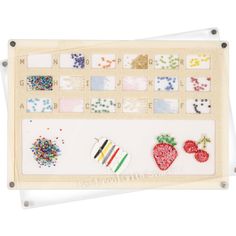 the bead and sequin board is made from wood, with several different designs on it