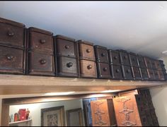 many drawers are stacked on top of each other in front of a mirror and light