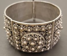 This cuff bracelet fits around a 7" wrist. It is solid silver. It is a beautiful vintage or antique piece. The clasp is a pin sliding down, very cool! Adjustable Ornate Cuff Bracelet With Intricate Design, Adjustable Vintage Cuff Bracelet For Festivals, Vintage Adjustable Cuff Bracelet For Festivals, Ornate Adjustable Cuff Bracelet With Intricate Design, Handmade Ornate Cuff Bracelet, Vintage Cuff Bracelet With Intricate Bangle Design, Vintage Bangle Cuff Bracelet With Intricate Design, Antique Adjustable Cuff Bracelet With Intricate Design, Vintage Cuff Bracelet With Intricate Design