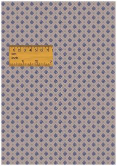 a ruler on top of a fabric with blue and white designs in the background,