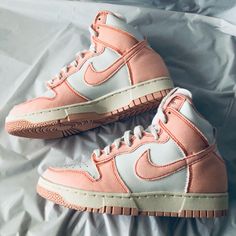 The Nike Dunk High “1985” Arctic Orange W Was Included In The Women's Catalog. It Arrived In An Artic Orange, Summit White, And Sail Colorway. The Shoes Upper Is Made Of A Pure White Leather Base And Canvas Overlays Across The Heel, Around The Toe And Along The Tongue. It Also Features A Tall Cushioned Collar And A Tiny Pull Tab Attached To Its Rear. Branding Details Include A Nike Branding Tag On The Tongue And Nike Swooshes On Both Sides. The Sneaker Rides On A White Accented Rubber Midsole At Retro Nike Custom Sneakers With Contrast Sole, Custom Retro Sneakers For Streetwear, Vintage Nike Sneakers With Boost Midsole, Vintage Nike Sneakers With Boost Technology, Retro Basketball Shoes With Contrast Sole, Retro High-top Custom Sneakers, Nike Custom Sneakers For Spring Streetwear, Trendy Nike Custom High-top Sneakers, Nike Custom Sneakers With Gum Sole For Spring