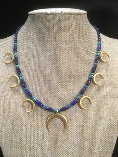 "Ancient style Lunula or Crescent moon necklaces with a variety of genuine gemstone options! Beautiful 22k gold plated pendants to compliment your ancient Roman, Greek, Parthian, Coptic or any other Bronze age persona! You can wear them with your prettiest T shirt and jeans outfit. Earrings that compliment these necklaces can be found in my Etsy shop here. https://www.etsy.com/listing/817662134/ancient-style-lunula-crescent-mooref=shop_home_active_2 These necklaces are finished with 14k gold fil Artisan Necklace With Moon Charm, Artisan Crescent Moon Charm Necklaces, Artisan Crescent Moon Charm Necklace, Artisan Crescent Jewelry Hand Forged, Artisan Hand Forged Crescent Jewelry, Artisan Hand-forged Crescent Jewelry, Celestial Crescent Jewelry For Healing, Artisan Crescent Moon Charm Jewelry, Crescent Moon Charm Amulet Jewelry