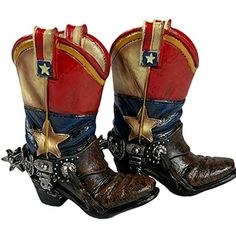 pair of cowboy boots with stars and chains on the soles, side by side