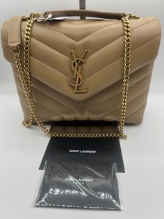 Stunning!!! YSL Yves Saint Laurent Small Lou Lou Puffer Bag in Natural Tan Leather!!! YSL Yves Saint Laurent Small size Lou Lou Puffer Bag, Shoulder Bag, Crossbody in Natural t Leather. Authentic. Timeless piece!!! Comes with original dust bag, tags, authenticity cards and a gift receipt. Also YSL gift box. Beautiful YSL handbag with gold logo on a tan leather with gold hardware. The bag measures 9” L x 7” H x 3.5” D Strap: from 12” to 22” adjustable Made in Italy! Retail: over $3200 with tax Th Ysl Handbag, Saint Laurent Purse, Ysl Handbags, Puffer Bag, Tan Leather Bag, Saint Laurent Handbags, Grey Bag, Lou Lou, Natural Tan