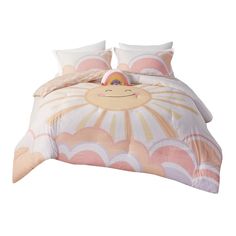 a bed with an orange and white comforter on top of it next to pillows