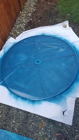 a large blue object sitting on top of a cement slab