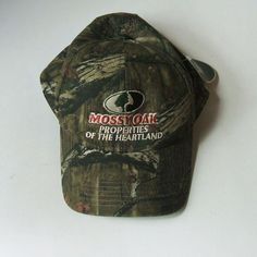 One camo cloth baseball cap style hat advertising Mossy Oak Properties of the Heartland. One size fits most with adjustable velcro.  Made in China.  Official licensed product.  New with tags. Terms & conditions: Buyer pays shipping. Items shipped to address provided by ebay, no exceptions. Email questions before bidding/buying. US sales only. Payment due within 2 days of end of auction/purchase. I ship 3 times a week.  I will not delay shipping at request of buyer. Read item description; items sold as is. I have a limited return policy. If you have an issue contact me. Adjustable Camouflage Cotton Baseball Cap, Adjustable Cotton Camouflage Baseball Cap, Outdoor Camouflage Cotton Baseball Cap, Camouflage Sports Cap, Outdoor Camouflage Adjustable Baseball Cap, Adjustable Camouflage Baseball Cap For Hunting, Camouflage Baseball Cap For Outdoor Activities, Casual Snapback Hat For Hunting, Hat Advertising