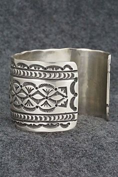 This stunning sterling silver bracelet was made by Navajo silversmith Leonard Maloney. The back is signed Maloney and stamped sterling.Size: 6" (will fit up to a 6 3/8" wrist)Gap: 1 3/8"Width: 1 3/4"Free shipping on all orders! We ship with USPS and always include tracking. All orders ship within a day of payment.Returns are accepted up to 30 days after you receive your order. Just send us a message. Our shop offers cash back or store credit. The item must be returned in new condition. Silver Untreated Cuff Bracelet Gift, Southwestern Silver Cuff Bracelet, Untreated Sterling Silver Bracelet, Unique Adjustable Etched Sterling Silver Bracelet, Artisan Sterling Silver Cuff Bracelet For Collectors, Unique Etched Adjustable Sterling Silver Bracelet, Artisan Sterling Silver Bracelet, Unique Etched Sterling Silver Adjustable Bracelet, Bohemian Etched Sterling Silver Bracelets