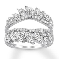 a white gold ring with three rows of diamonds on the sides and two rows of leaves