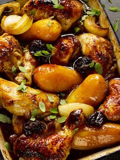 chicken and potatoes in a baking dish with herbs