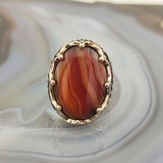 The ring is made of 925 sterling silver and adorned with Striped agate stone. PRODUCT FEATURES -Products are shipped with free shipping with box and bag. - Crafting Material : 925K Sterling Silver - Weight : 18.0 grams - Gemstone Diameter : 18 x 25 mm - Gemstone :Striped agate - Gender : Male / Female ✔ Ready to Ship in 1-3 Business Days ✔ Shipped to the worldwide 1-3 business days with free express shipping. ✔ The product will be sent to you with a box to avoid any damage during shipping. Diges Oval Agate Rings With Polished Finish, Oval Agate Signet Ring With Polished Finish, Polished Agate Oval Cabochon Rings, Oval Cabochon Agate Ring With Polished Finish, Oval Agate Hallmarked Rings, Oval Agate Ring With Large Stone, Oval Brown Agate Rings, Brown Oval Agate Rings, Silver Men Ring