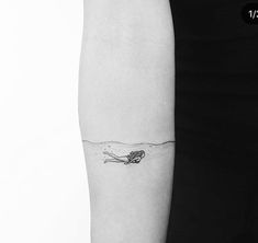 a woman's arm with a small tattoo on the left side of her body