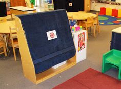 a classroom filled with lots of desks and colorful chairs for children to sit on