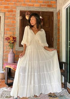 "Handmade bohemian cotton wedding dress. Bat wing sleeves. 2 layers of ruffled sleeve. V neckline front and back with the string to tied. Elastic waist. Lined. Color Cream Adjustable with strings at the back. 100%  natural soft Cotton. Color Off white Beige. Model 5'6 Measurements: One size fit most figure. Chest up to 46 Waist 20 stretch up to 46 \" Length 56 inches. Sleeve 16 Hip. 56\" ( measure from the inside lining) CARE: Machine wash cold. NOTE: All my dresses are already wash it part of t Cotton Wedding Dress, Wedding Dress Maternity, Cotton Wedding Dresses, Boho Maternity Dress, Maxi Dress Beach, Ethiopian Traditional Dress, Wedding Dressses, Wedding Dress Boho, Boho Maternity