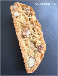 a piece of bread with nuts and crumbs on it