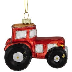 a red tractor ornament hanging from a chain