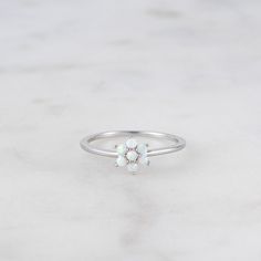 Delicate opal ring, that is perfect for stacking or wearing alone. A true beauty and must have! Made of 925 Sterling Silver We use a THICK DURABLE 14k Gold, Rose Gold or Rhodium plating - for a piece that will last you years to come! Lab Created Opal Stones - made of the highest quality for an authentic look! Available in sizes 4-10 Nickel-Free & Hypoallergenic Ring Measurements: Flower: 7.5mm Band Width: 1mm Layering Diamond Necklaces, Opal Stacking Ring, Gold Opal Ring, Sterling Silver Opal Ring, Silver Opal Ring, Ring Opal, Opal Ring Gold, Opal Engagement, Opal Earrings Stud